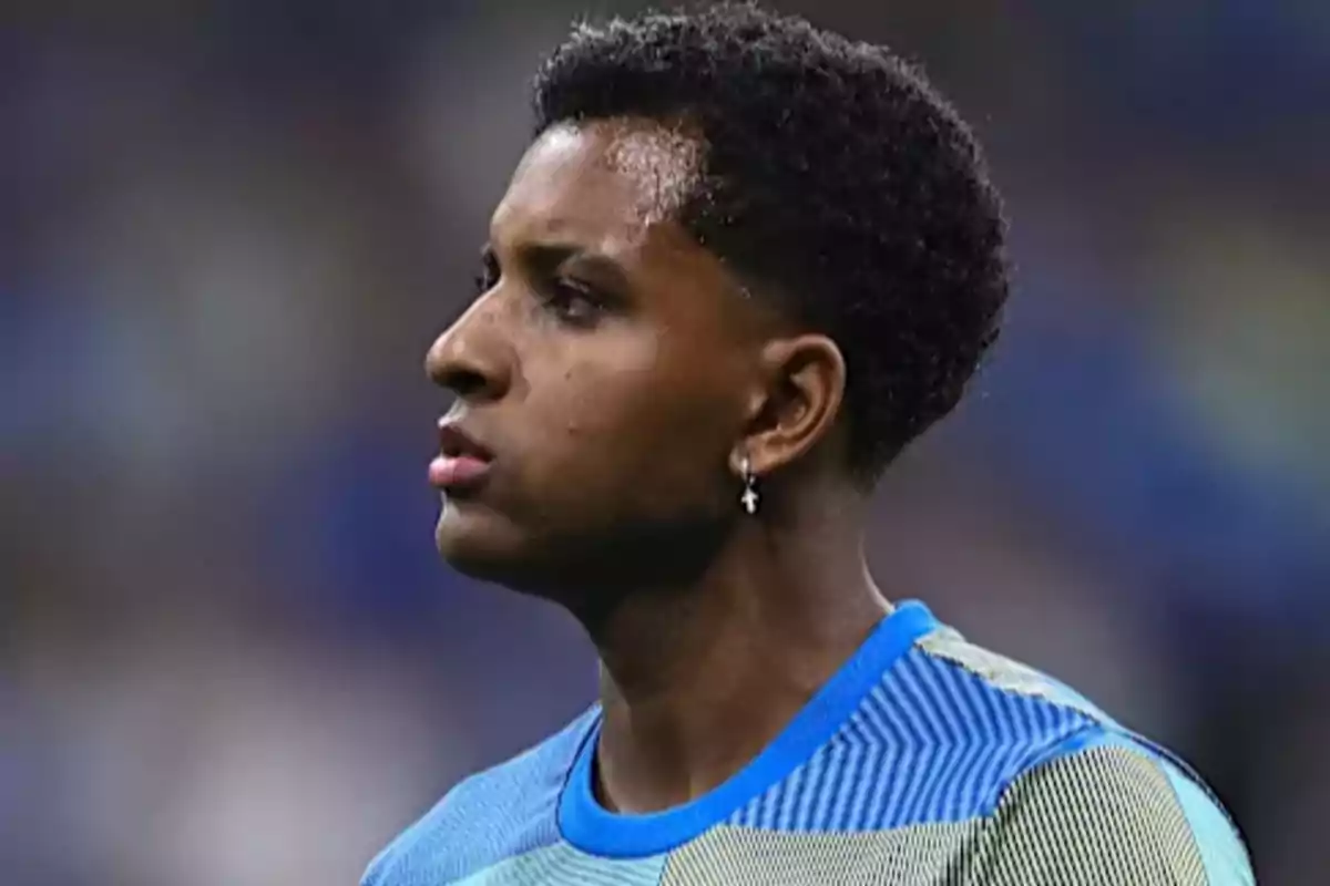 Young player wearing a blue jersey and an earring in his left ear looking to the left Young player wearing a blue jersey and an earring in his left ear looking to the left