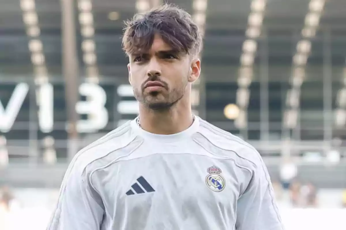 Soccer player wearing a white Real Madrid training jersey in a stadium Soccer player wearing a white Real Madrid training jersey in a stadium