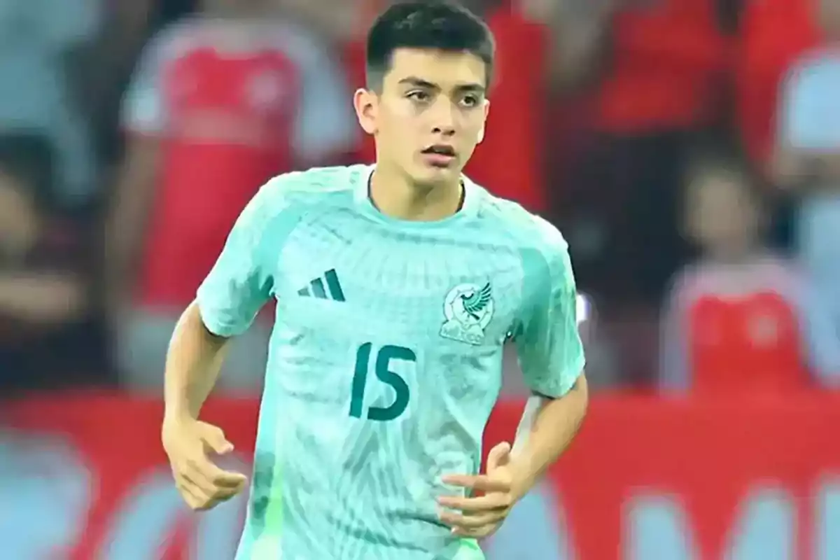 Young player in a light green uniform with the number 15 during a match Young player in a light green uniform with the number 15 during a match