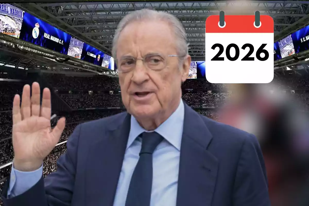 Older man with glasses and a suit raising his hand in a soccer stadium with a calendar showing the year 2026