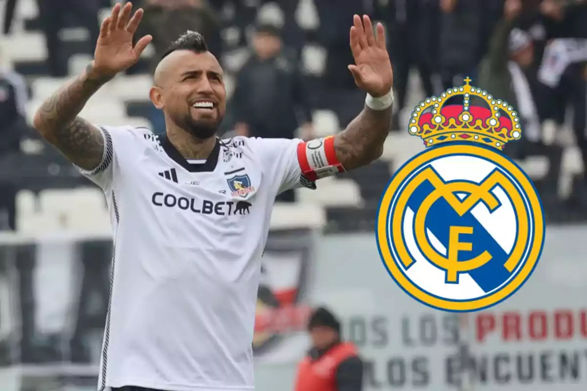 Soccer player in a white uniform with a red armband raising his hands next to the Real Madrid crest