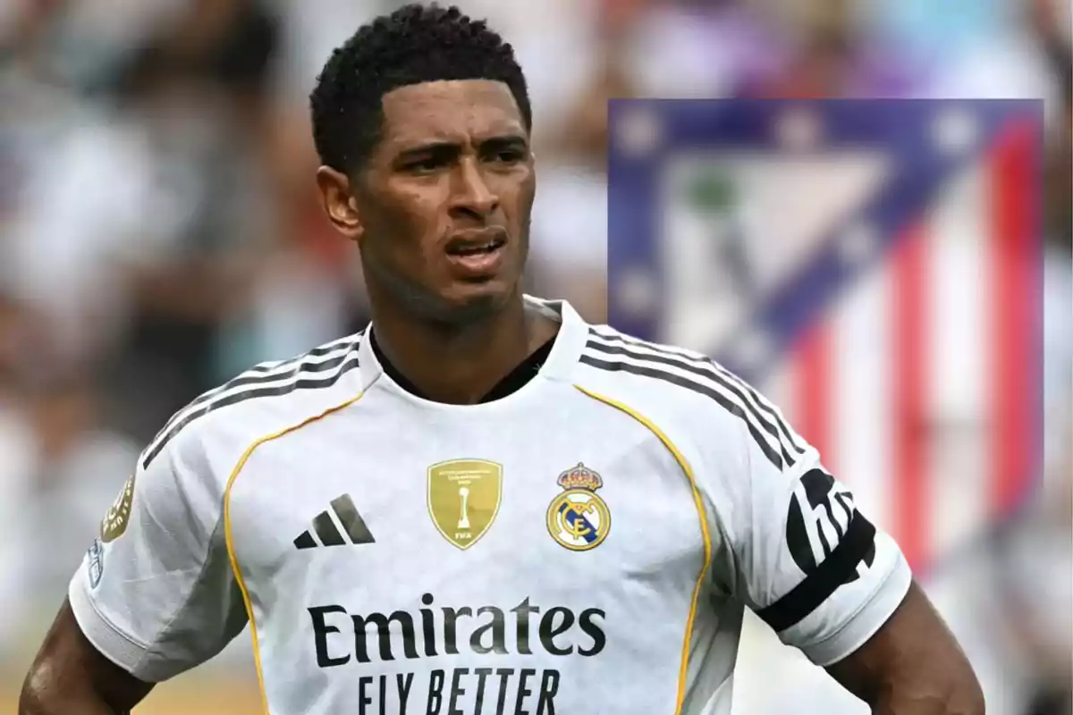Real Madrid player with a serious expression on the field and the Atlético de Madrid crest blurred in the background
