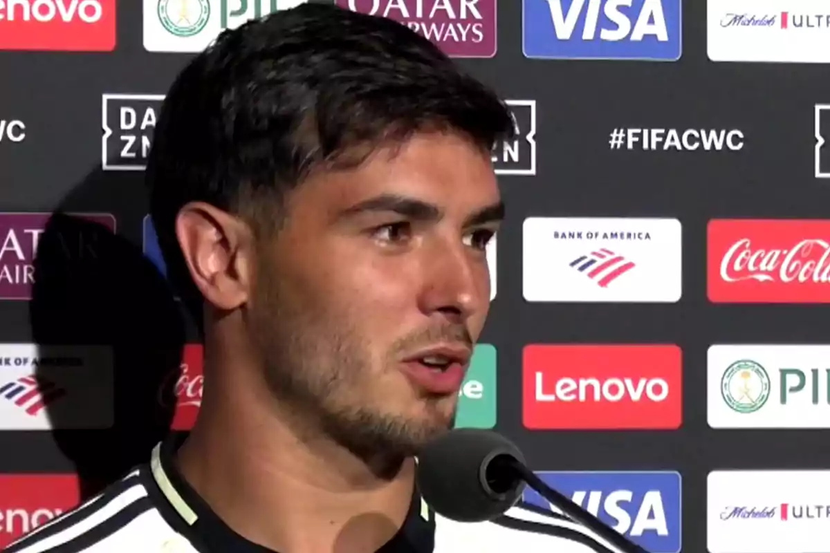 A player giving an interview in front of a backdrop with sponsor logos A player giving an interview in front of a backdrop with sponsor logos