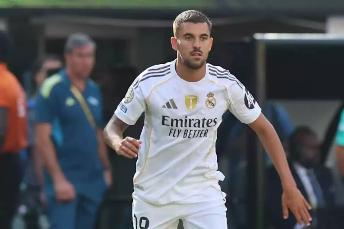 Real Madrid player in a white uniform on the field during a match Real Madrid player in a white uniform on the field during a match