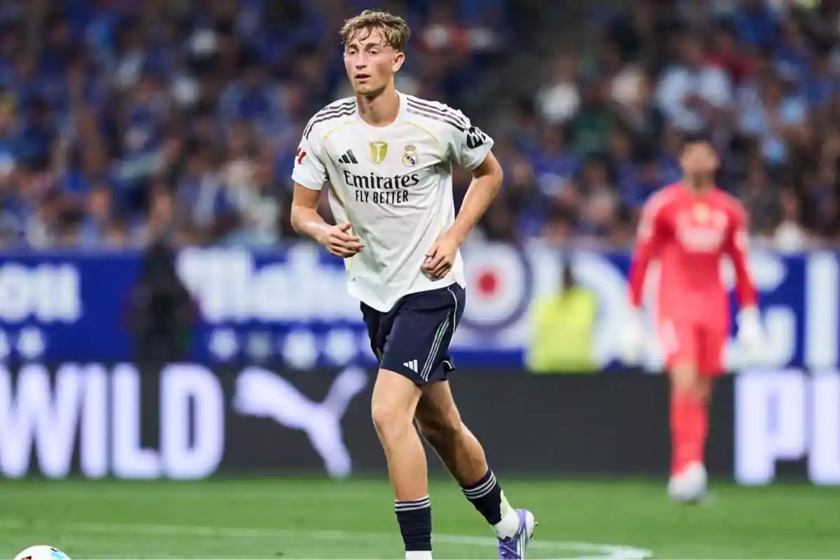 Real Madrid player running on the field during a soccer match with the crowd in the background. Real Madrid player running on the field during a soccer match with the crowd in the background.