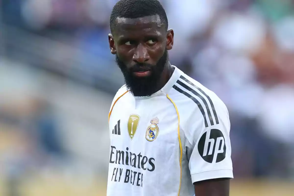 Real Madrid player with a serious expression during a match, wearing the team's white uniform Real Madrid player with a serious expression during a match, wearing the team's white uniform