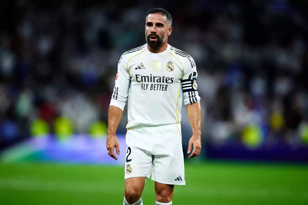 Real Madrid player wearing the white uniform with the captain's armband in a match