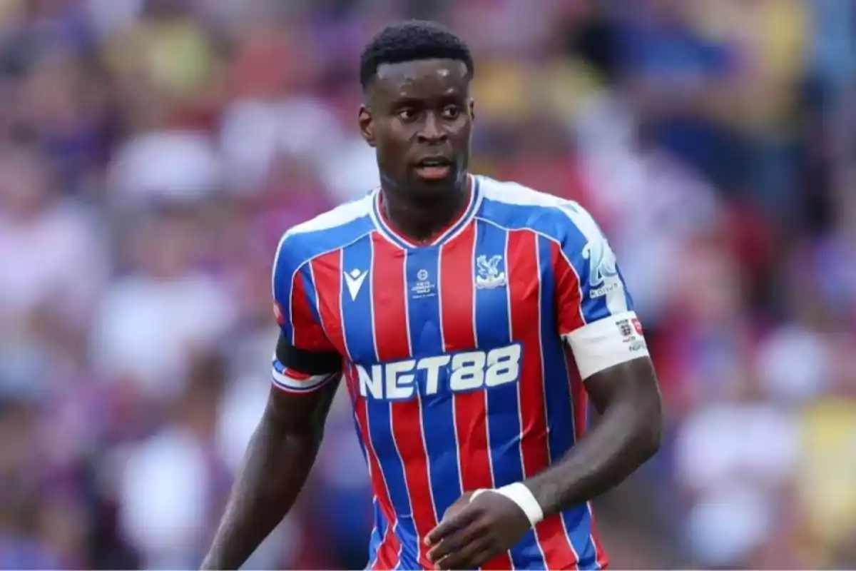Soccer player in a red and blue striped uniform during a match Soccer player in a red and blue striped uniform during a match