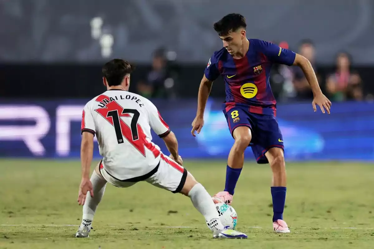 Two players compete for the ball during a match between Barcelona and Rayo Vallecano. Two players compete for the ball during a match between Barcelona and Rayo Vallecano.