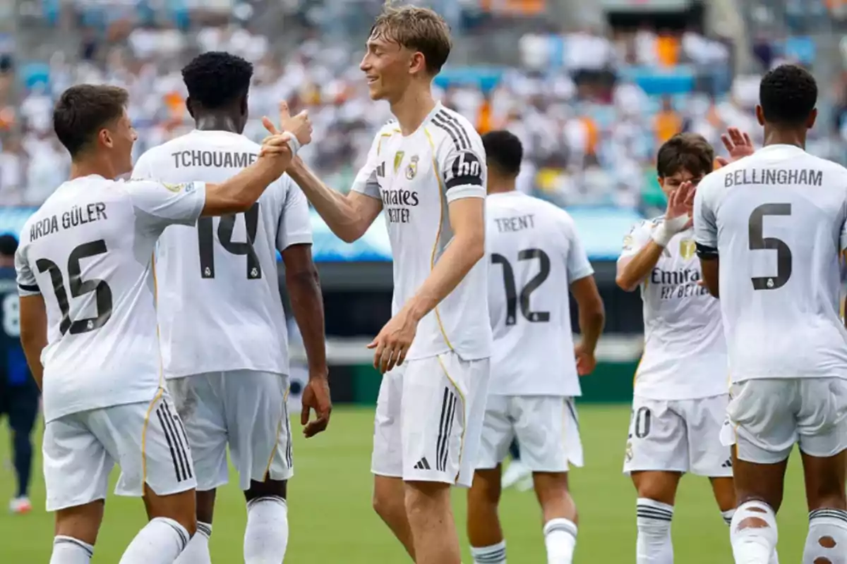 Real Madrid players celebrate together on the field during a soccer match Real Madrid players celebrate together on the field during a soccer match