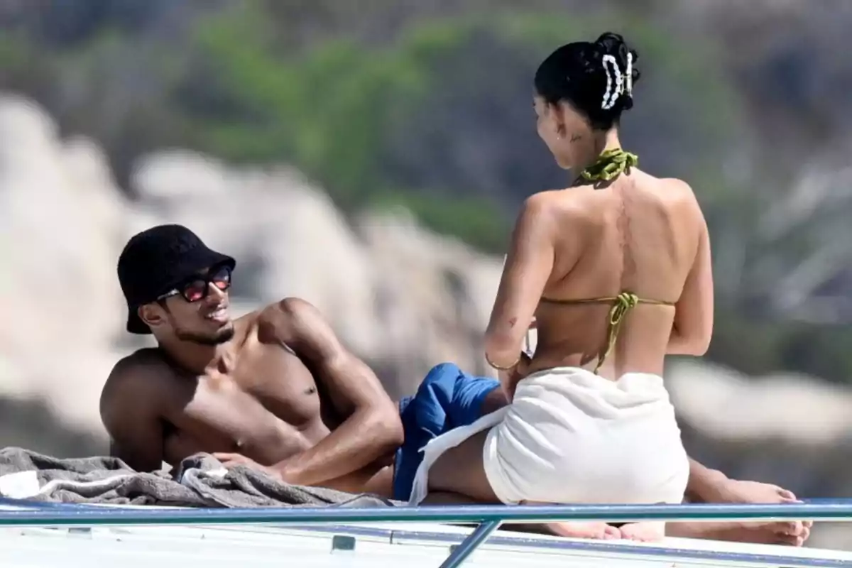 Two people are enjoying a sunny day on a yacht, relaxing and talking. Two people are enjoying a sunny day on a yacht, relaxing and talking.
