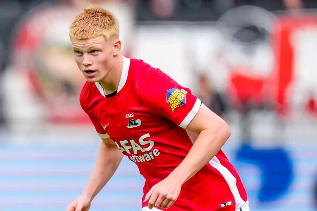 Soccer player in a red uniform during a match Soccer player in a red uniform during a match