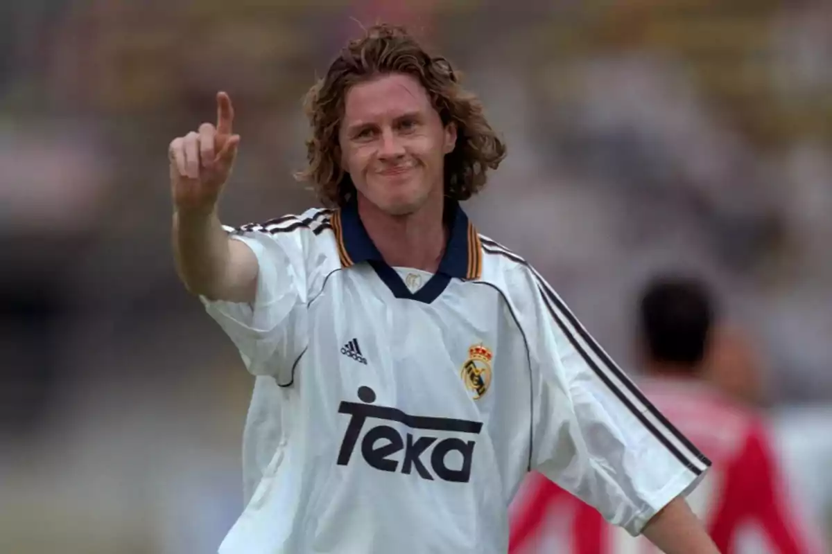 Soccer player wearing a white Real Madrid jersey celebrating on the field Soccer player wearing a white Real Madrid jersey celebrating on the field