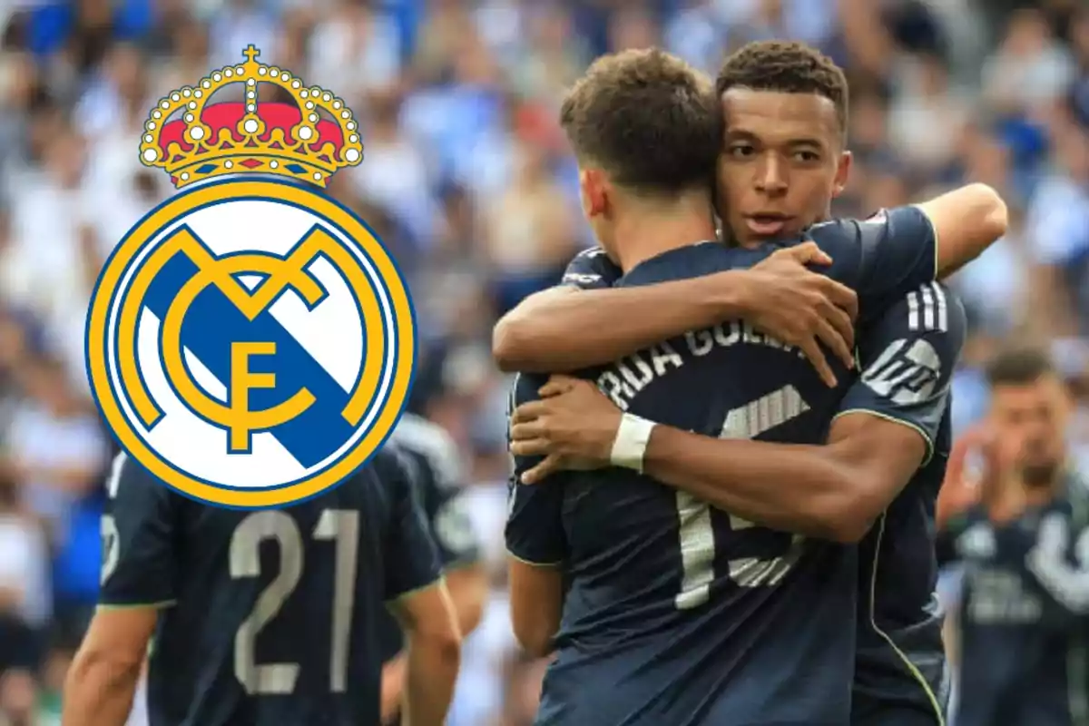 Two players hug while celebrating a goal as the Real Madrid crest covers the face of one of them.