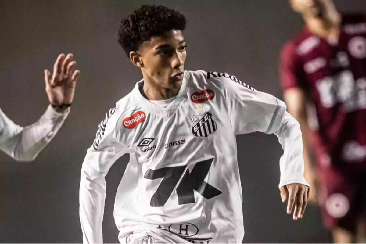 Soccer player in a white Santos FC uniform in action during a match Soccer player in a white Santos FC uniform in action during a match