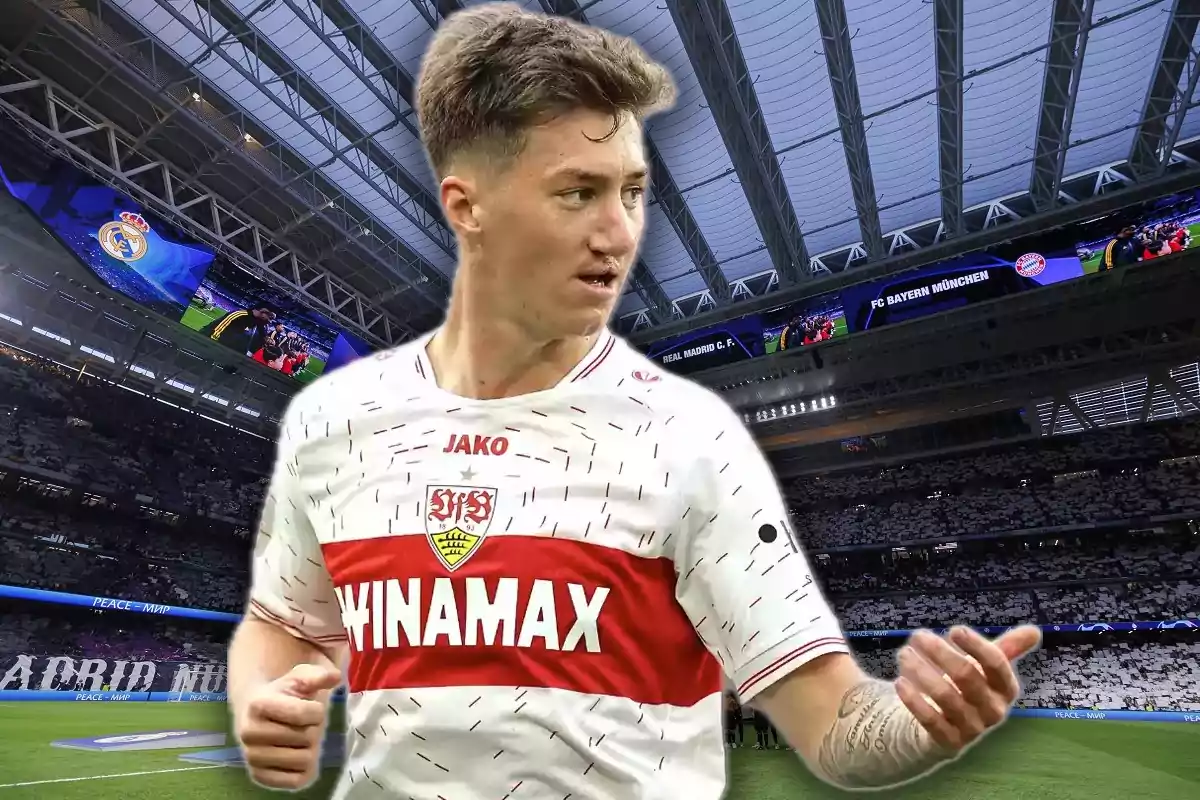 Soccer player in a white and red Stuttgart uniform inside a modern football stadium with a retractable roof and giant screens
