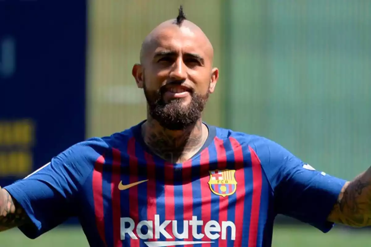Soccer player wearing an FC Barcelona jersey smiles on a training field Soccer player wearing an FC Barcelona jersey smiles on a training field
