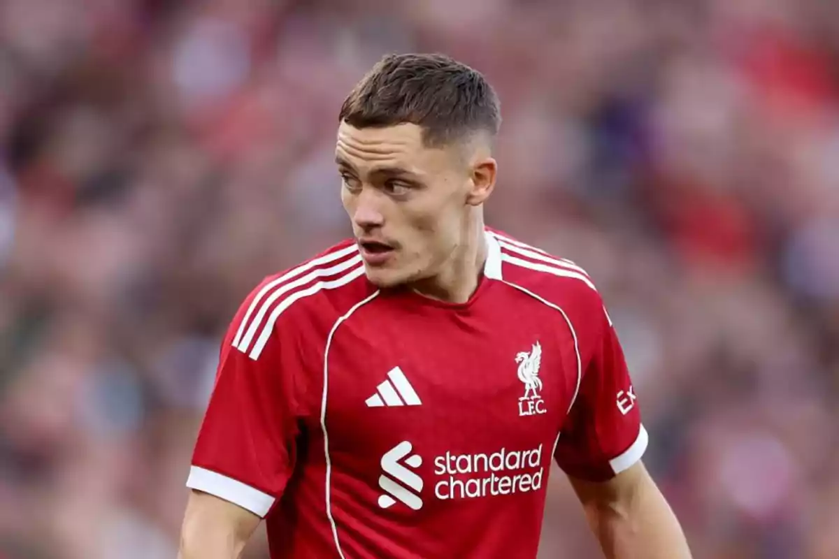 Soccer player wearing a red Liverpool jersey during a match Soccer player wearing a red Liverpool jersey during a match