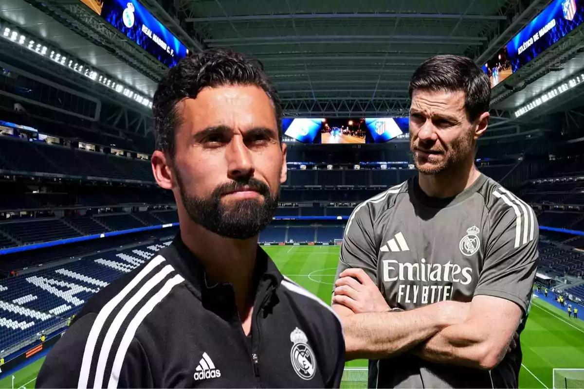Two coaches wearing Real Madrid training gear pose at Santiago Bernabéu Stadium.