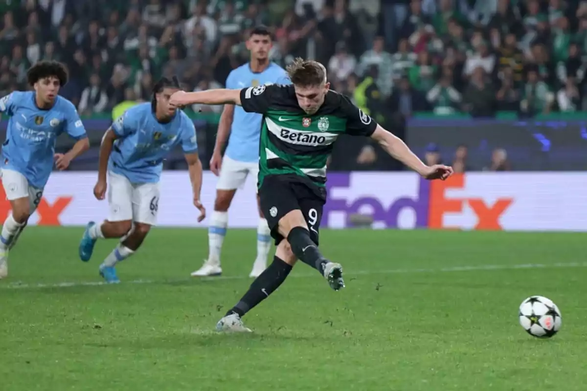 A football player in a green and black uniform kicks a ball into a game while other players watch.