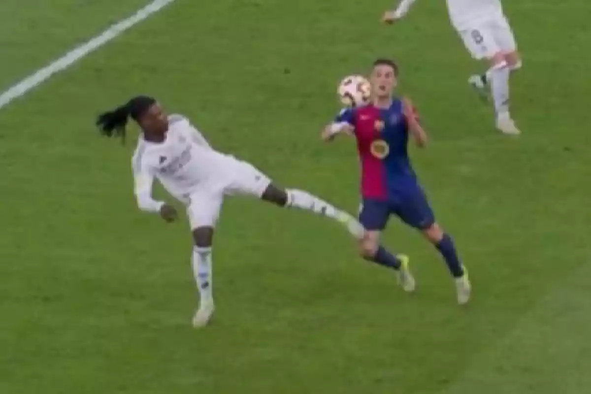 Two soccer players compete for the ball on the field. Two soccer players compete for the ball on the field.