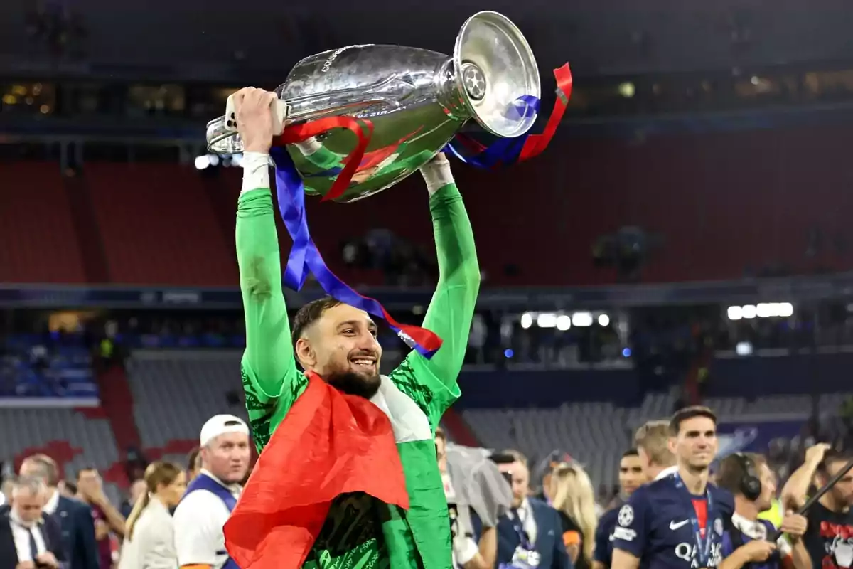 Goalkeeper celebrating with a soccer trophy held high and a flag draped over his shoulders in a stadium full of people Goalkeeper celebrating with a soccer trophy held high and a flag draped over his shoulders in a stadium full of people