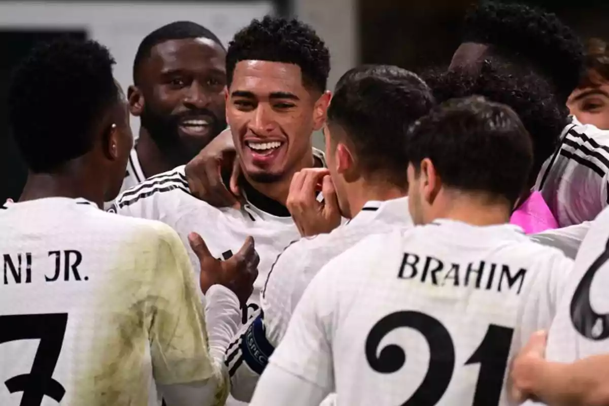 A group of soccer players celebrating together on the field.