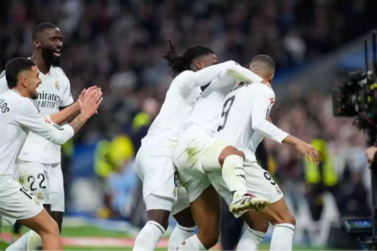 Jugadores de fútbol celebrando un gol en el campo.