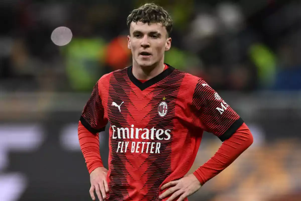 A soccer player in the red and black uniform of AC Milan on the playing field. A soccer player in the red and black uniform of AC Milan on the playing field.