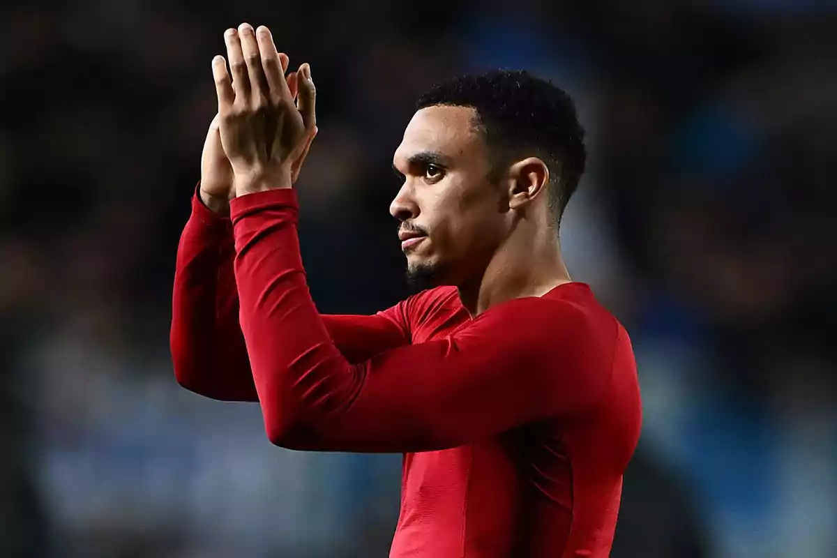 Person in red t-jersey clapping in dark environment. Person in red t-jersey clapping in dark environment.
