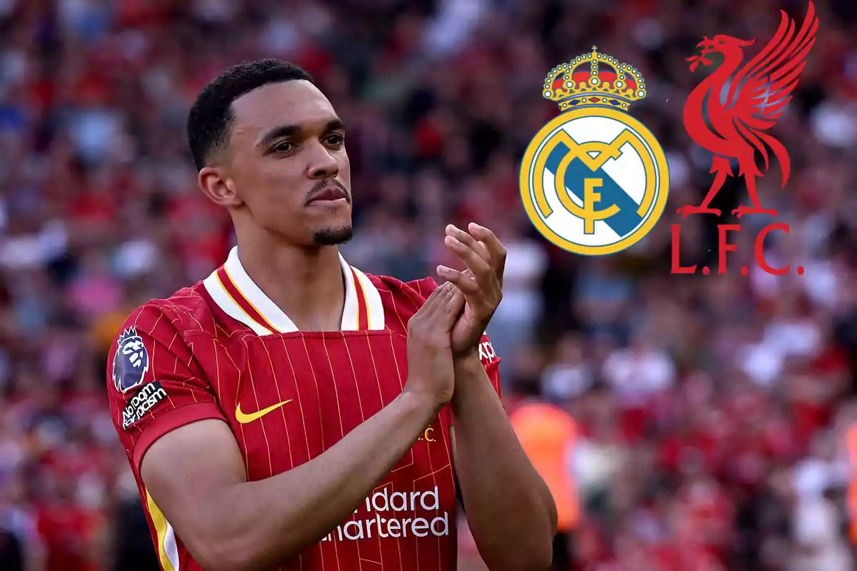 A player in a red uniform applauds in a stadium, with the logos of Real Madrid and Liverpool in the background.