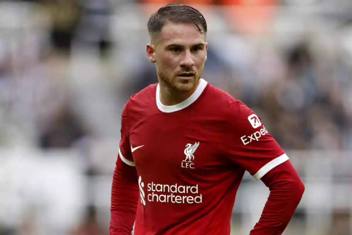 Soccer player in a red Liverpool jersey on the field. Soccer player in a red Liverpool jersey on the field.