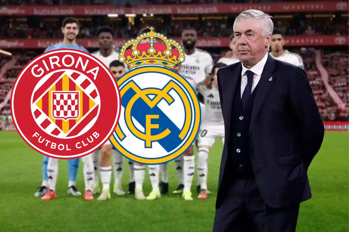 A soccer coach standing next to the Girona FC and Real Madrid crests in a stadium.