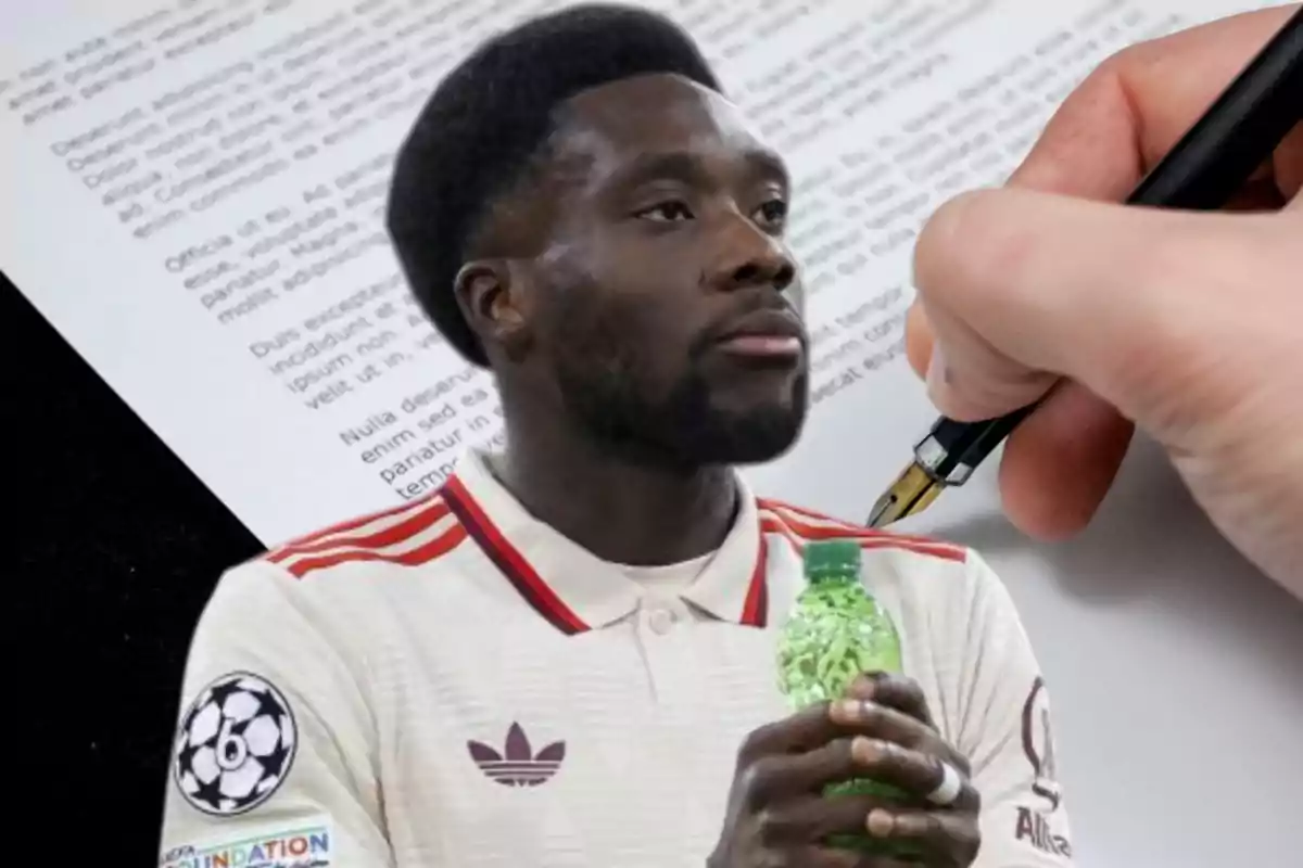 A man in a sports jersey holds a green bottle while a hand writes on a document.