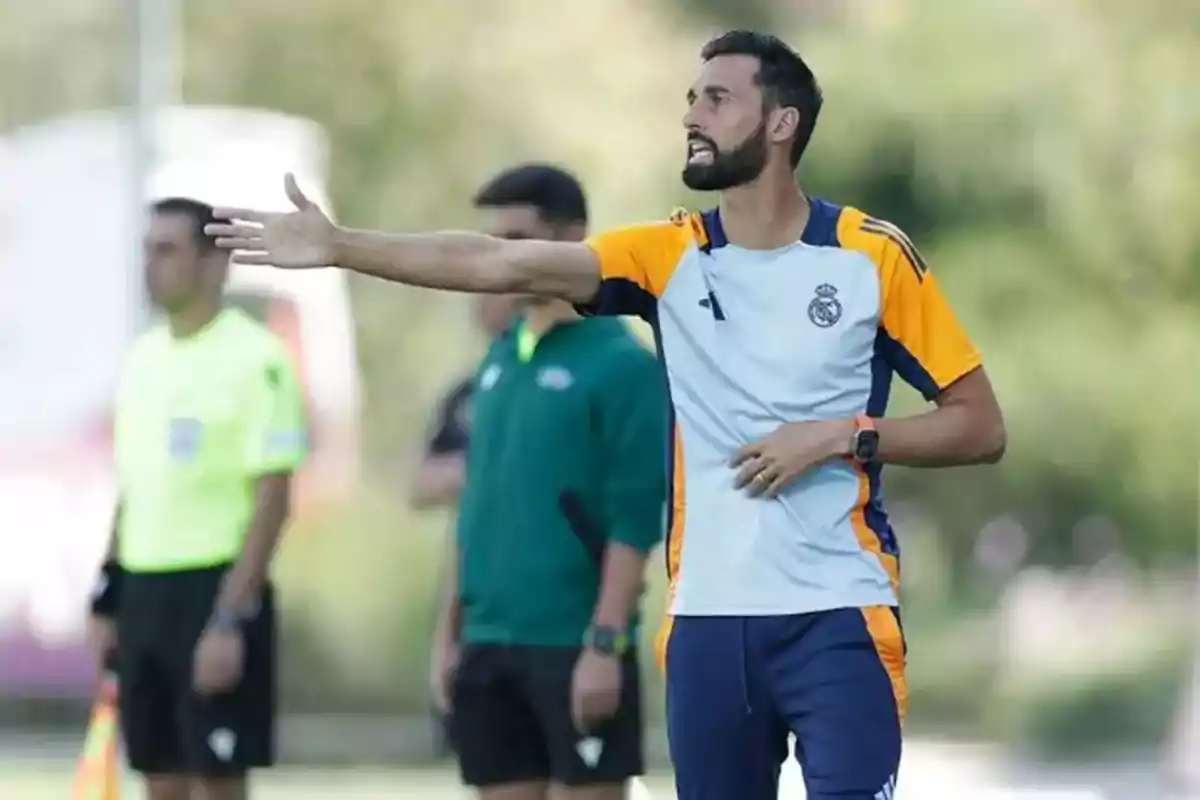 Soccer coach wearing a Real Madrid uniform giving instructions on the field during a match Soccer coach wearing a Real Madrid uniform giving instructions on the field during a match