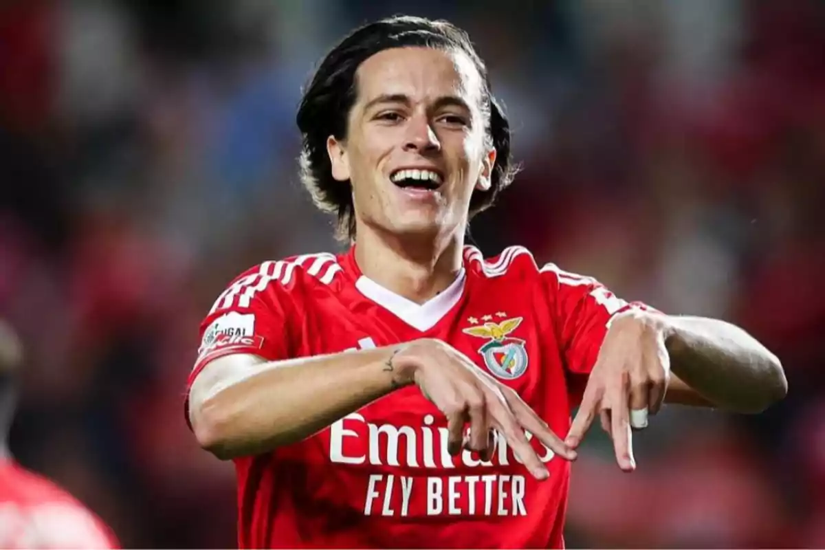 Soccer player wearing a red Benfica jersey celebrating a goal in the stadium Soccer player wearing a red Benfica jersey celebrating a goal in the stadium