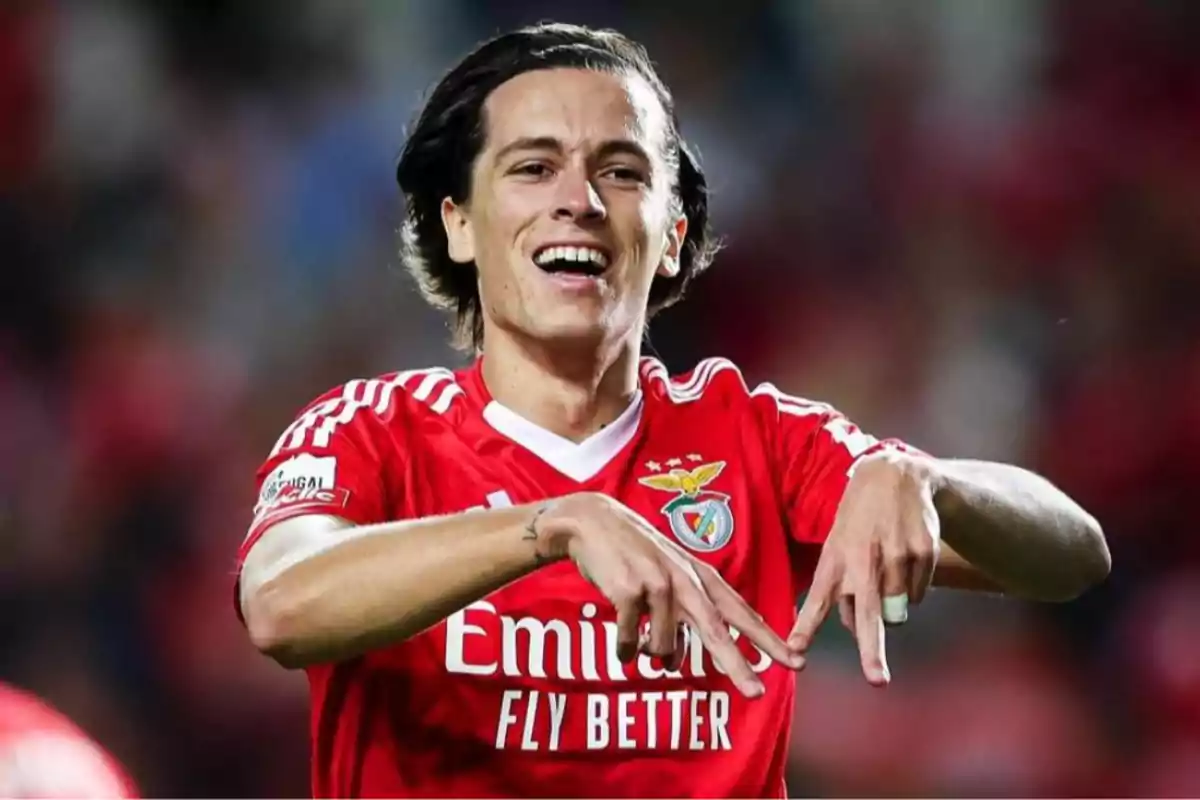 Soccer player in a red jersey celebrating on the field. Soccer player in a red jersey celebrating on the field.
