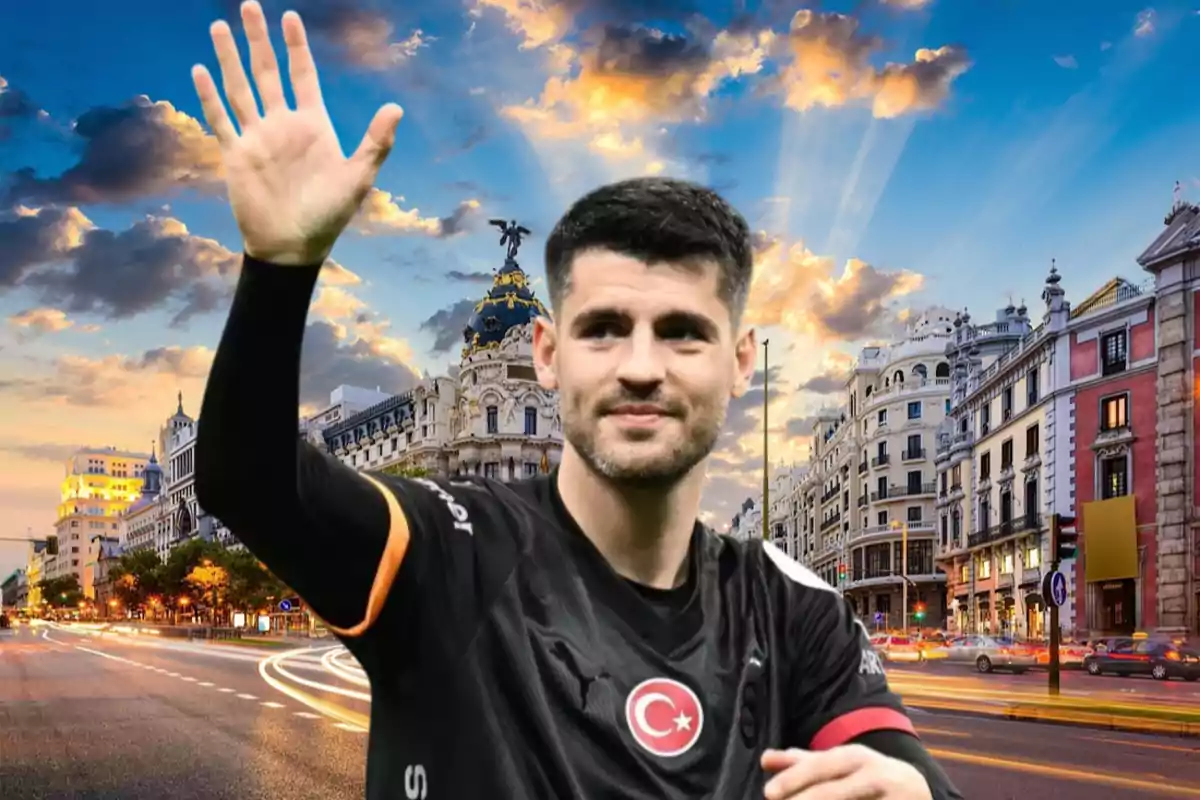 A man in a black sports jersey waves in front of a cityscape at sunset.