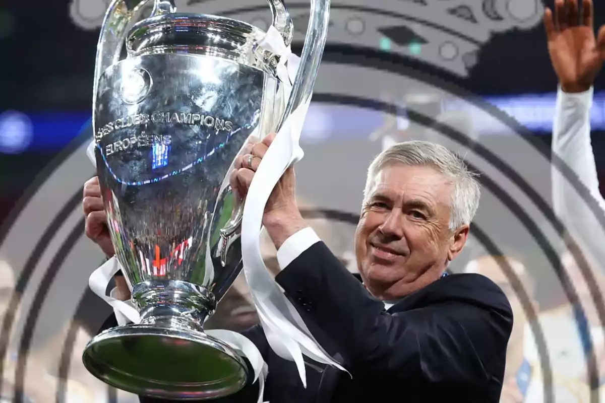 A man holding a large silver trophy with a look of satisfaction.