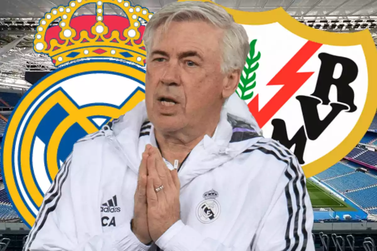 Un entrenador de fútbol con chaqueta blanca está frente a los escudos del Real Madrid y Rayo Vallecano en un estadio.