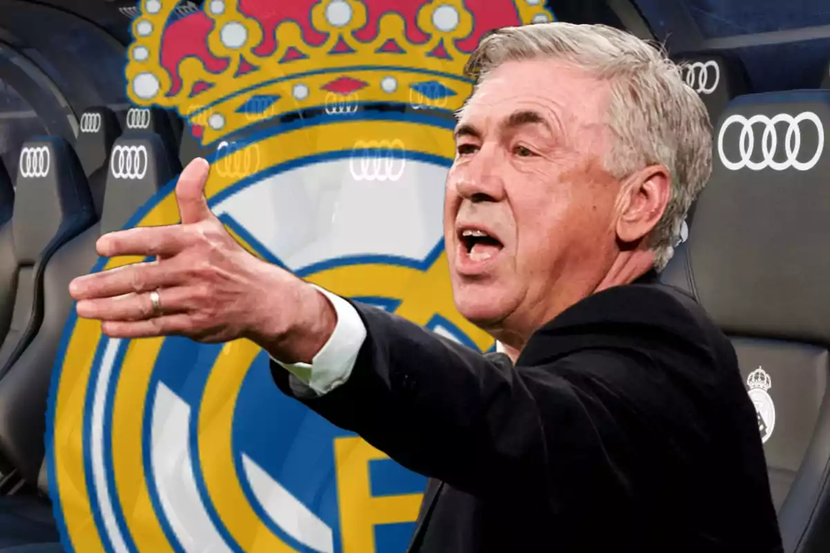 A man gesturing with an outstretched arm in front of a background with a soccer team crest and stadium seats.