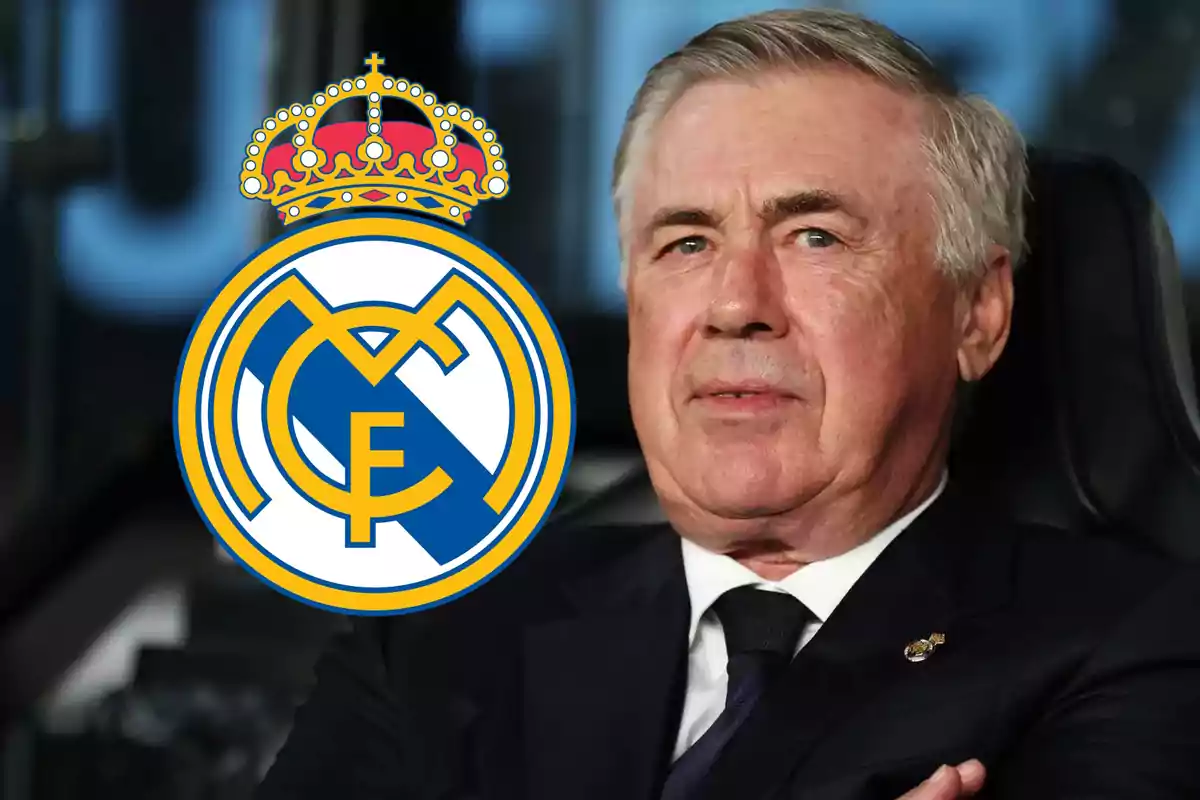 Hombre de cabello canoso en traje oscuro junto al escudo del Real Madrid.