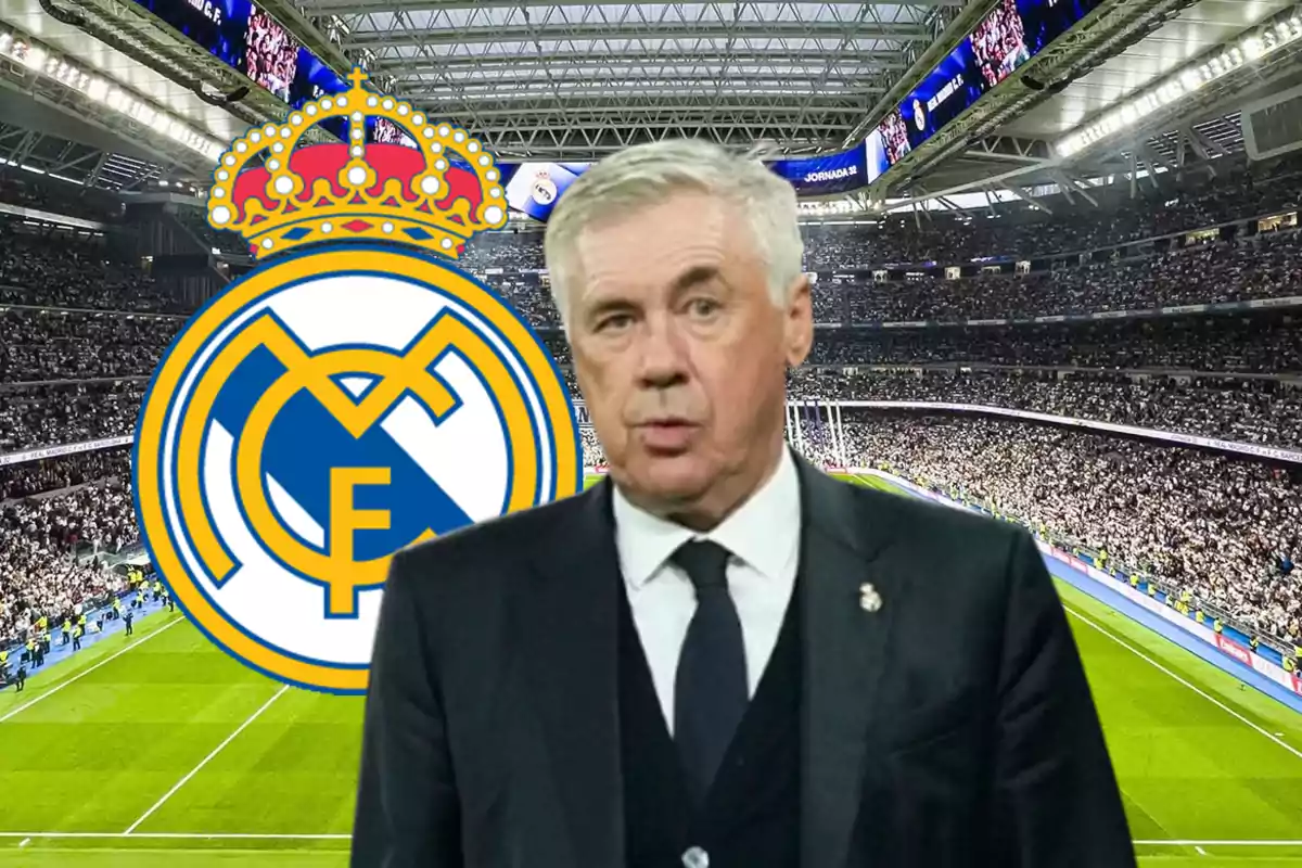 A man in a suit in front of the Real Madrid logo in a stadium full of spectators.