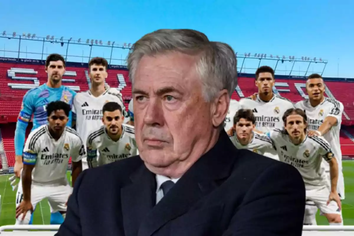 A soccer coach with a serious expression is in the foreground, while behind him is a group of players in white uniforms posing in a stadium.