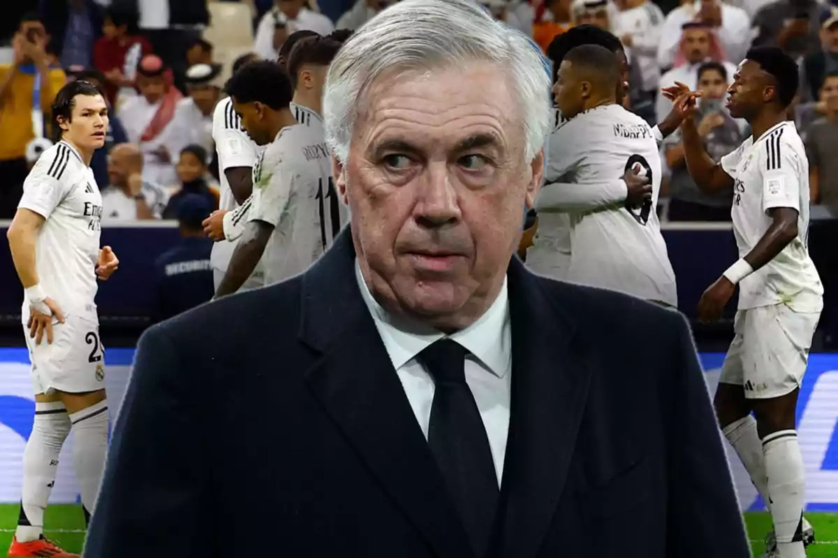 A soccer coach with a serious expression in the foreground and players of his team celebrating in the background.