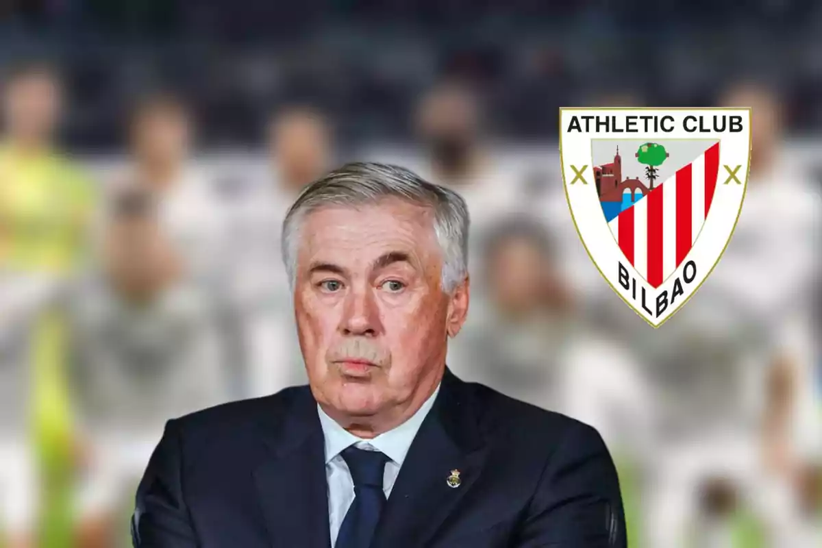 Un hombre de cabello canoso con traje oscuro aparece frente a un fondo desenfocado con el escudo del Athletic Club Bilbao a su lado.