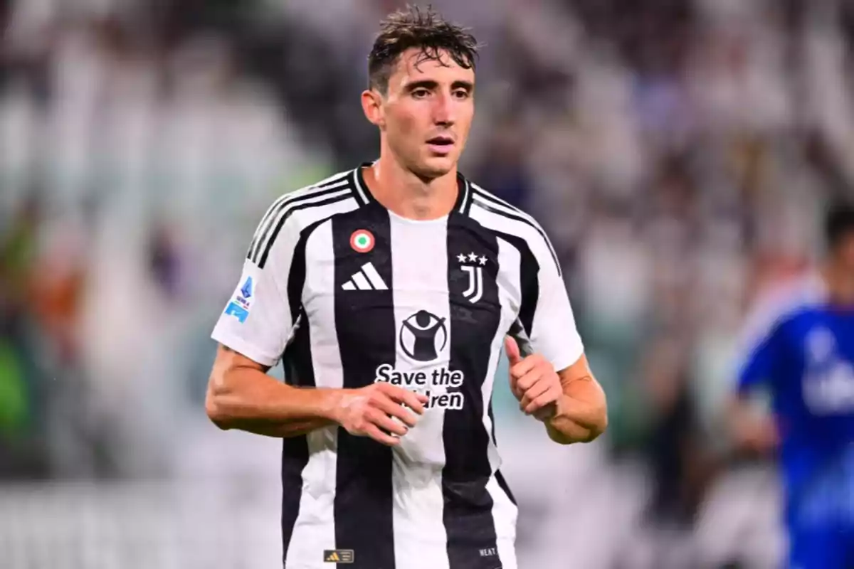 A soccer player in a Juventus uniform on the field. A soccer player in a Juventus uniform on the field.
