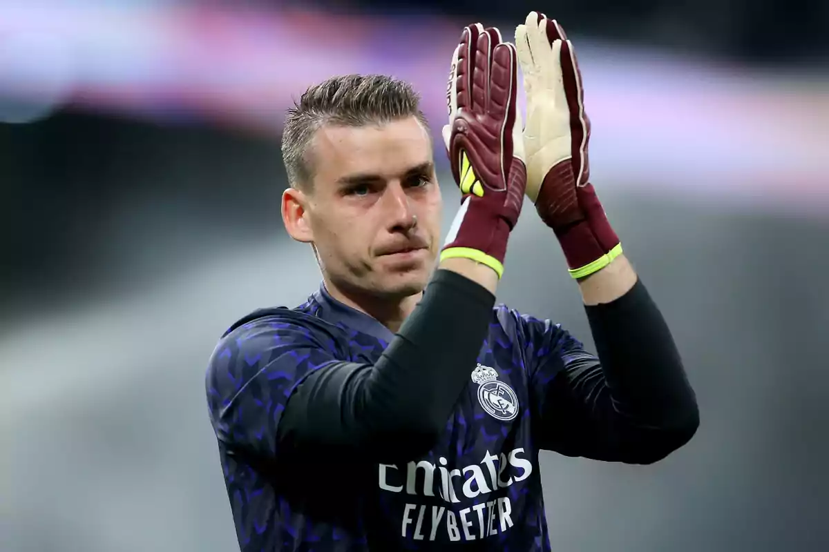 A player with gloves applauds on the field. A player with gloves applauds on the field.