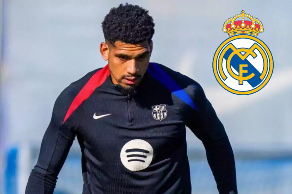 A soccer player in a FC Barcelona uniform with the Real Madrid crest in the background.