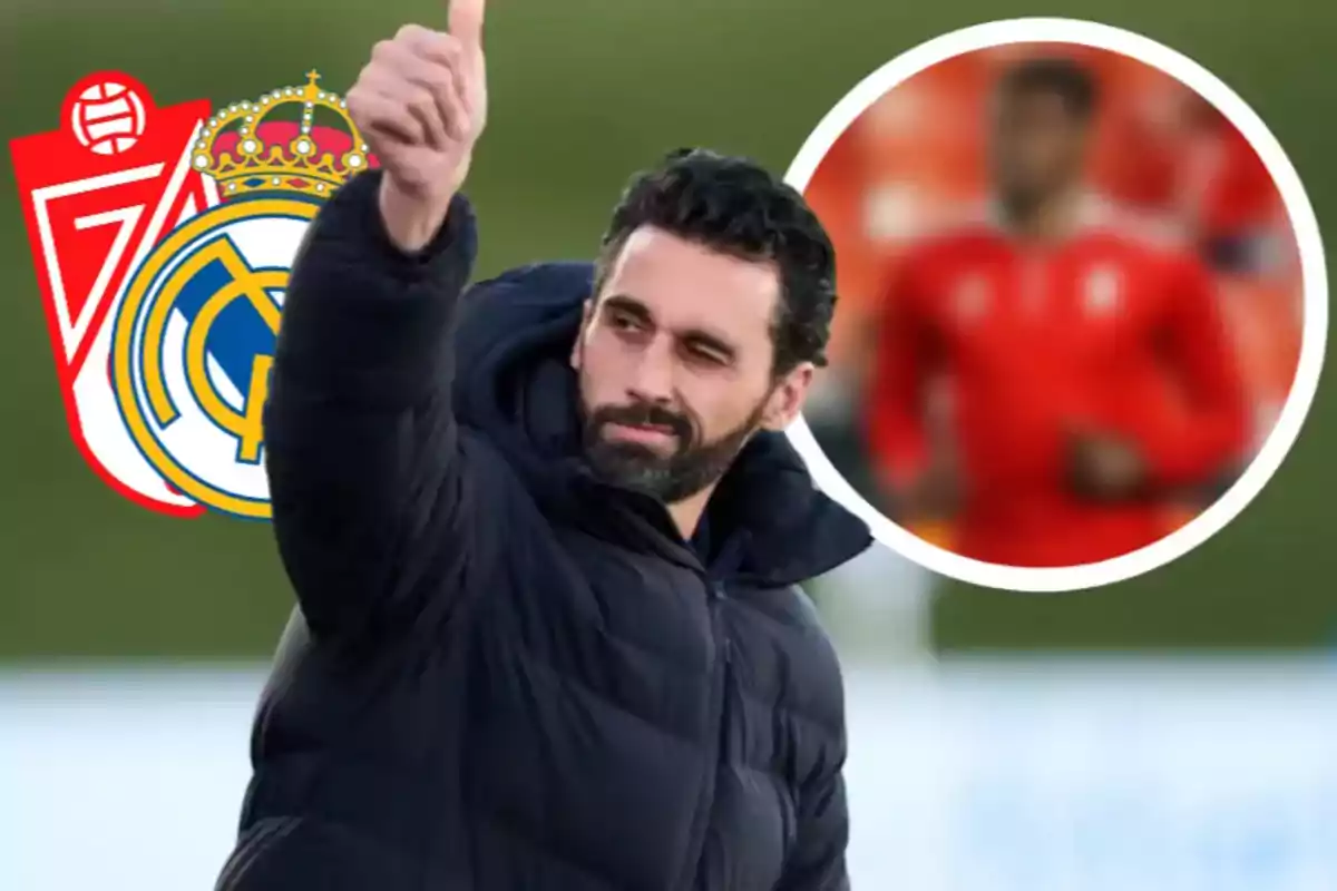 Hombre con barba y chaqueta negra levantando el pulgar con los escudos de Granada y Real Madrid al fondo